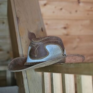 Handmade hat of white cow skin .